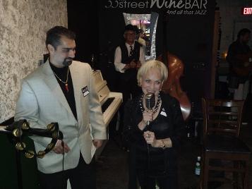 Kyle Cavaliere presenting Nuccia McCormick with an award and offering the microphone - sw florida luxury caviar experience